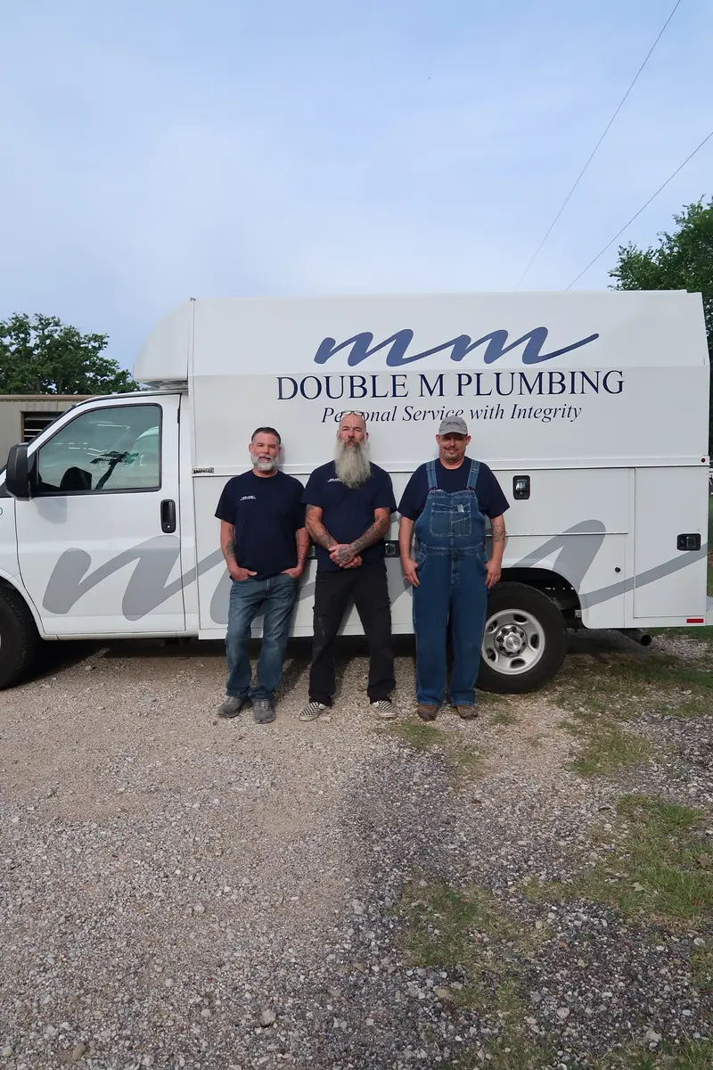 Professional plumber consulting with customer in residential setting