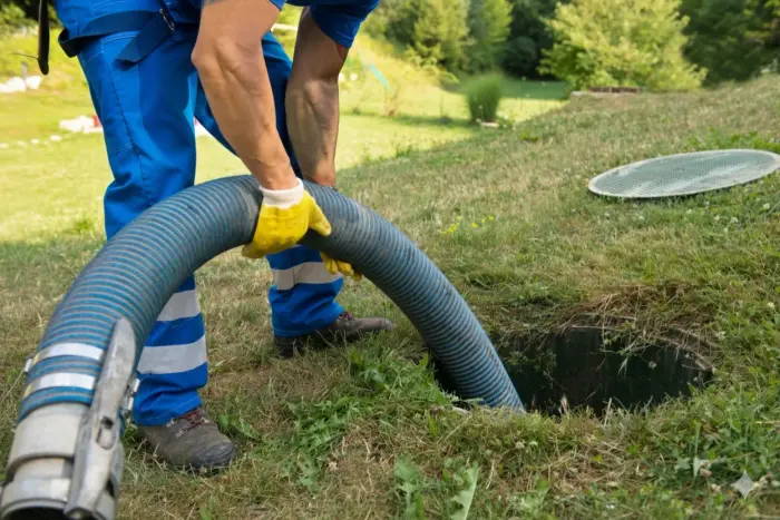 Professional technician performing sewer line maintenance with specialized equipment